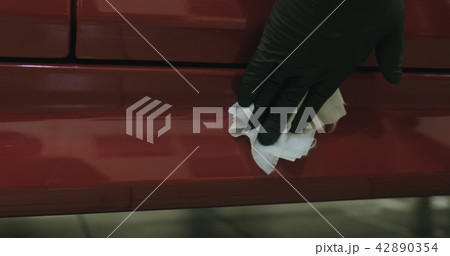 closeup of car paint degreasing with alcohol before polishing 42890354