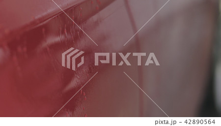 Closeup focus red car wash degreasing paint soak 42890564