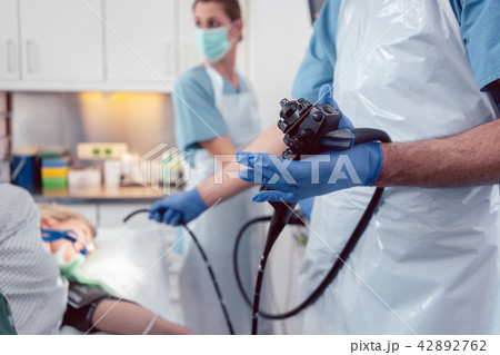 Team of doctors performing endoscopy in hospital Team of doctors performing endoscopy in hospital 42892762