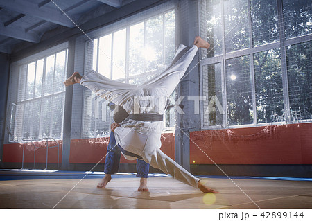 Two judo fighters showing technical skill while practicing martial arts in a fight club 42899144