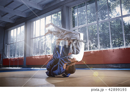 Two judo fighters showing technical skill while practicing martial arts in a fight club 42899193