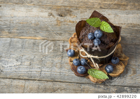 Chocolate muffin with mint and blueberries Chocolate muffin with mint and blueberries 42899220