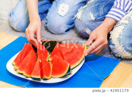 Family eating watermelon on floor 42901179