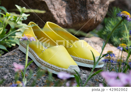 Yellow espadrilles on stones 42902002