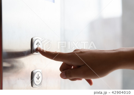 Close up woman hand press a up button of elevator Close up woman hand press a up button of elevator 42904010