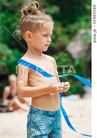 little serious boy standing on the beach little serious boy standing on the beach 42904589