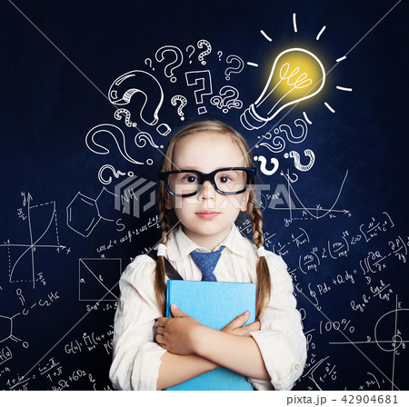 Cheerful child at the blackboard with lightbulb Cheerful child at the blackboard with lightbulb 42904681