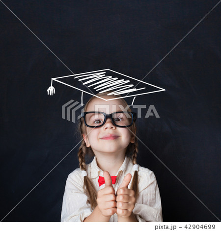 Little genius kid in  graduation hat with thumb up 42904699