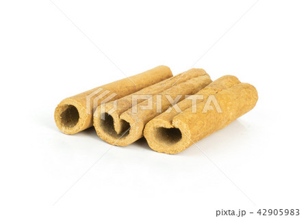 Dry brown cinnamon stick isolated on white Dry brown cinnamon stick isolated on white 42905983