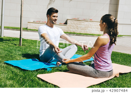 Delighted nice couple enjoying yoga Delighted nice couple enjoying yoga 42907484