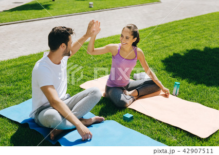 Cheerful happy people giving each other high five Cheerful happy people giving each other high five 42907511