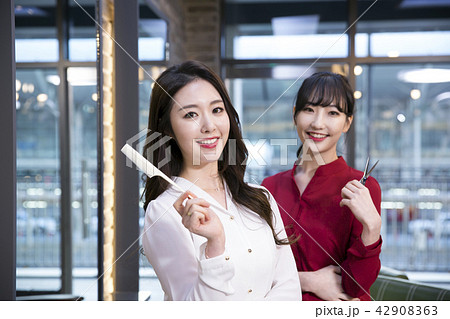 Hairdresser styling woman's hair in a salon. Korean beauty stock photo. 153 Hairdresser styling woman's hair in a salon. Korean beauty stock photo. 153 42908363