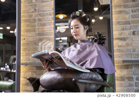 Hairdresser styling woman's hair in a salon. Korean beauty stock photo. 091 Hairdresser styling woman's hair in a salon. Korean beauty stock photo. 091 42908500