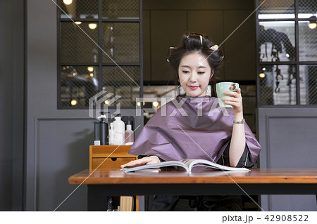 Hairdresser styling woman's hair in a salon. Korean beauty stock photo. 082 Hairdresser styling woman's hair in a salon. Korean beauty stock photo. 082 42908522