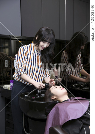 Hairdresser styling woman's hair in a salon. Korean beauty stock photo. 035 Hairdresser styling woman's hair in a salon. Korean beauty stock photo. 035 42908546