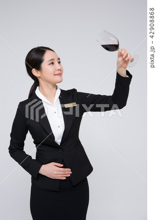 Catering services. Sommelier woman checking taste, smelling a wine isolated on white background 120 Catering services. Sommelier woman checking taste, smelling a wine isolated on white background 120 42908868