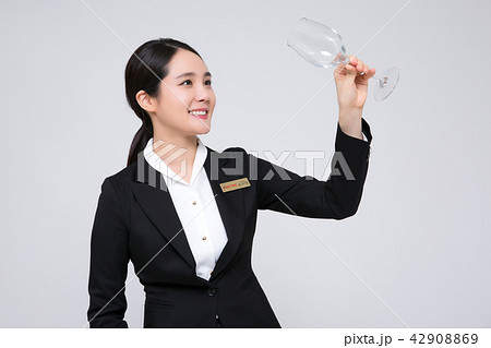 Catering services. Sommelier woman checking taste, smelling a wine isolated on white background 106 Catering services. Sommelier woman checking taste, smelling a wine isolated on white background 106 42908869