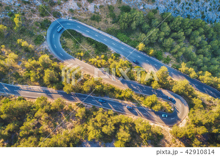 Aerial view of mountain curve road with cars 42910814