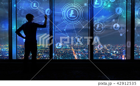 Litecoin with man by large windows at night Litecoin with man by large windows at night 42912535