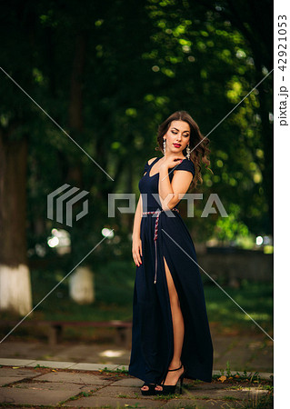 A beautiful girl in a blue dress is walking in...の写真素材 [42921053] - PIXTA
