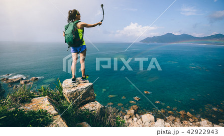 Woman Hiking In Seaside Taking A Selfie Woman Hiking In Seaside Taking A Selfie 42922943