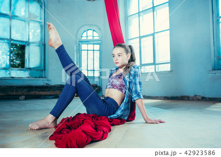 Graceful gymnast resting after performing aerial exercise at loft 42923586