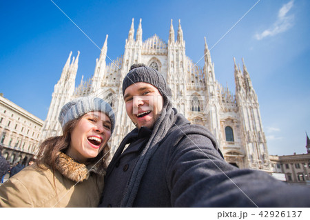 Couple taking self portrait in Duomo square in Milan. Traveling and relationship concept Couple taking self portrait in Duomo square in Milan. Traveling and relationship concept 42926137