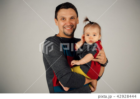 a little girl sitting on his father's hands a little girl sitting on his father's hands 42928444