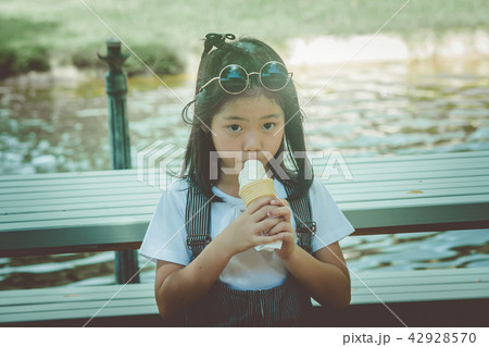 Portrait Asian little cute girl in the park. 42928570