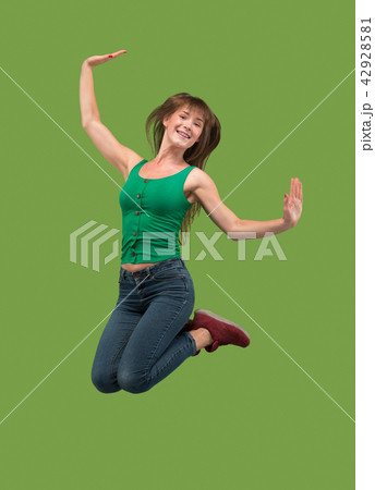Freedom in moving. Pretty young woman jumping against orange background 42928581