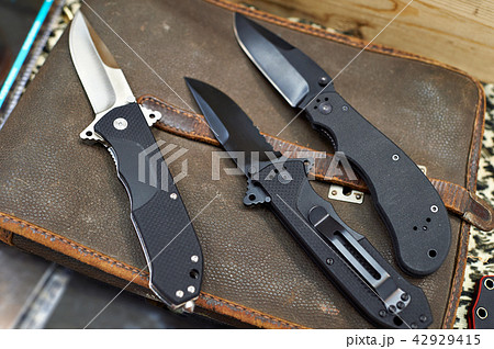Folding knives on leather retro bag tablet 42929415