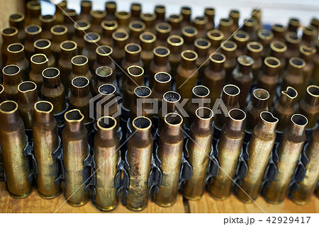 Brass cases of cartridges in machine-gun tape Brass cases of cartridges in machine-gun tape 42929417