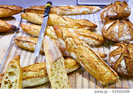 Fresh baguette bread with crust in bakery 42930206