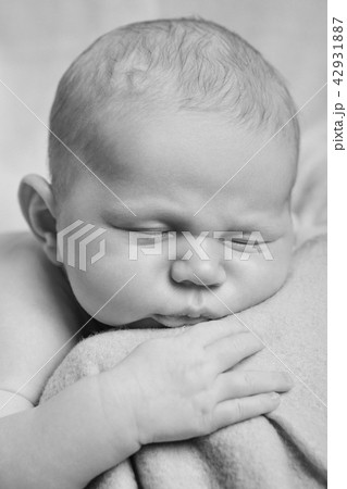 newborn baby lying on the hands of parents.  42931887