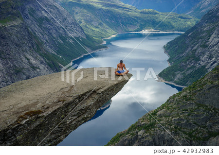 Yog is praying on the edge Trolltunga. Norway Yog is praying on the edge Trolltunga. Norway 42932983