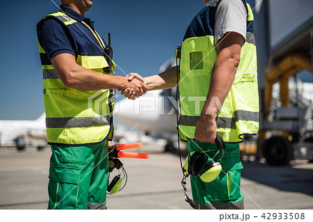 Airport workers shaking hands 42933508