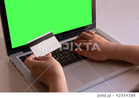 woman hand holding credit card and using laptop woman hand holding credit card and using laptop 42934386