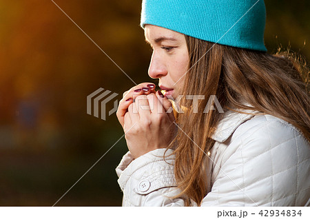 Cute brown haired woman with autumn leaves 42934834