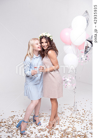 Smiling girlfriends having fun celebrating bachelorette party Smiling girlfriends having fun celebrating bachelorette party 42935935