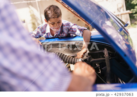 Old Man Grandpa Teaching Boy Fixing Car Engine Old Man Grandpa Teaching Boy Fixing Car Engine 42937063