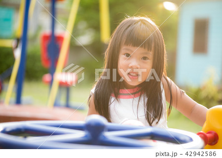 Happy little girl having fun on a playground 42942586