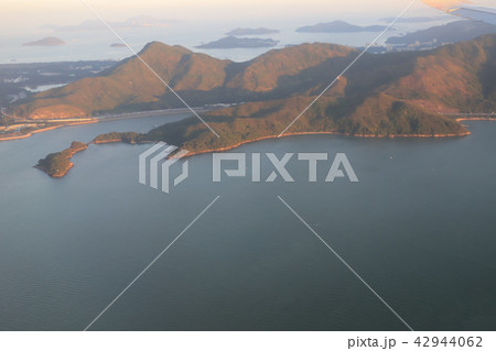 view of plane window looking down of a land 42944062