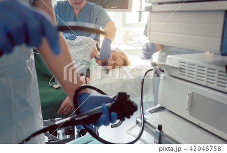 Internist doctors during stomach examination Internist doctors during stomach examination 42946758