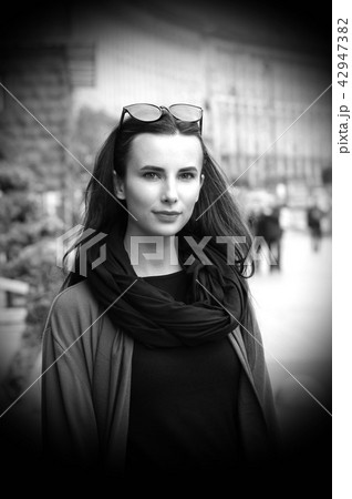 A black-haired girl  on the background of avenue 42947382
