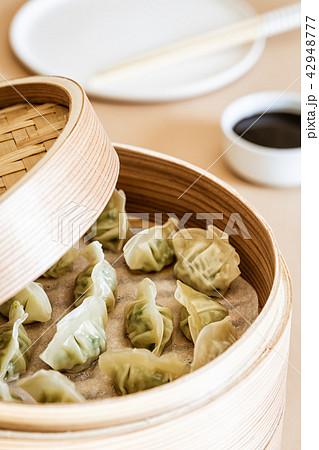 Asian gyoza, dumplings snack, chopsticks, steamer Asian gyoza, dumplings snack, chopsticks, steamer 42948777
