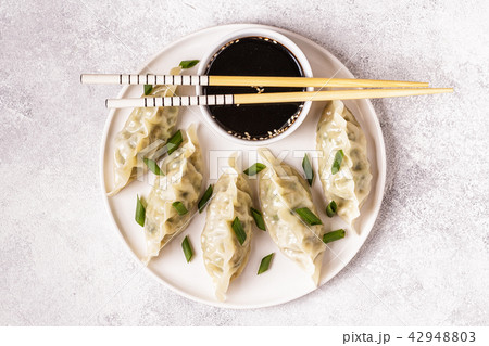 Asian dumplings, soy sauce, chopsticks, top view Asian dumplings, soy sauce, chopsticks, top view 42948803