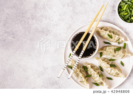 Asian dumplings, soy sauce, chopsticks, top view 42948806