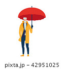 An elderly man in a yellow cloak with an umbrella. 42951025