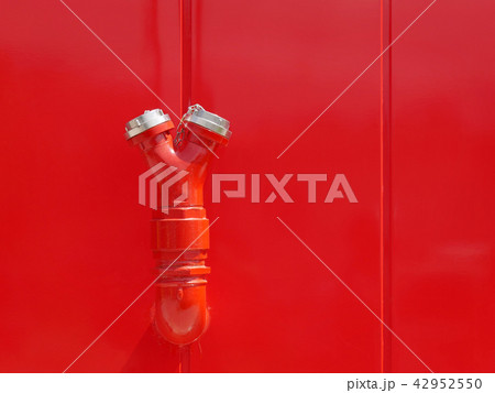 Red fire hydrant at wall Red fire hydrant at wall 42952550