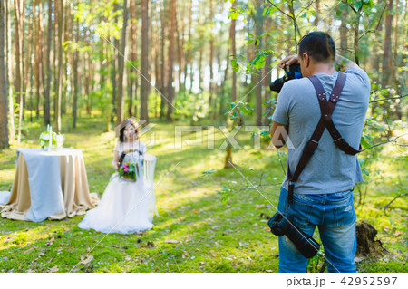 Photographer taking Pictures of the Bride in the forest 42952597
